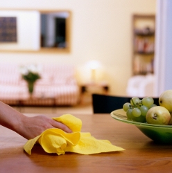 Someone cleaning a dining table